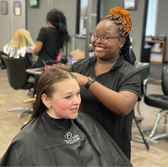 Cosmetology student styling hair