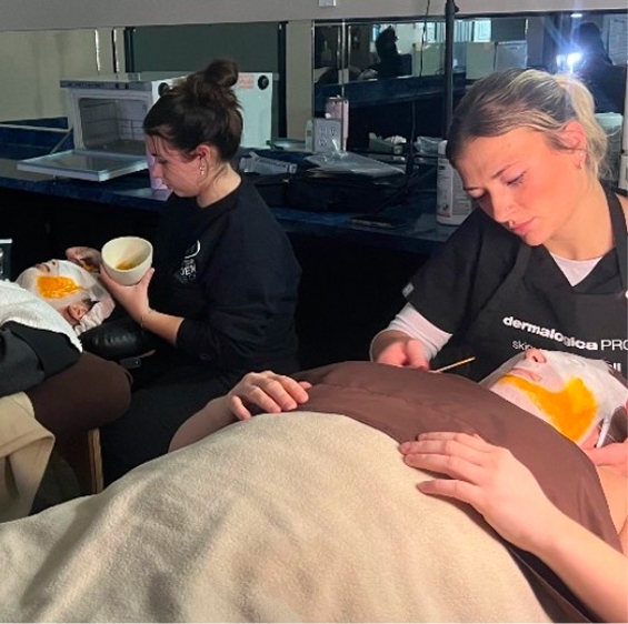 Esthetics student providing a facial treatment
