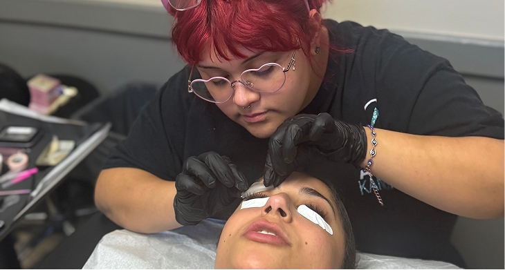 Student working with a salon guest